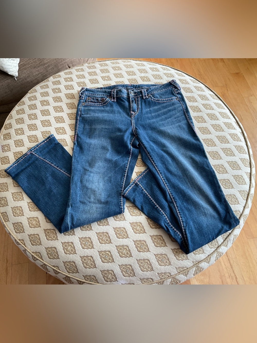 True Religion medium blue with original side seem. Light pink stitching.